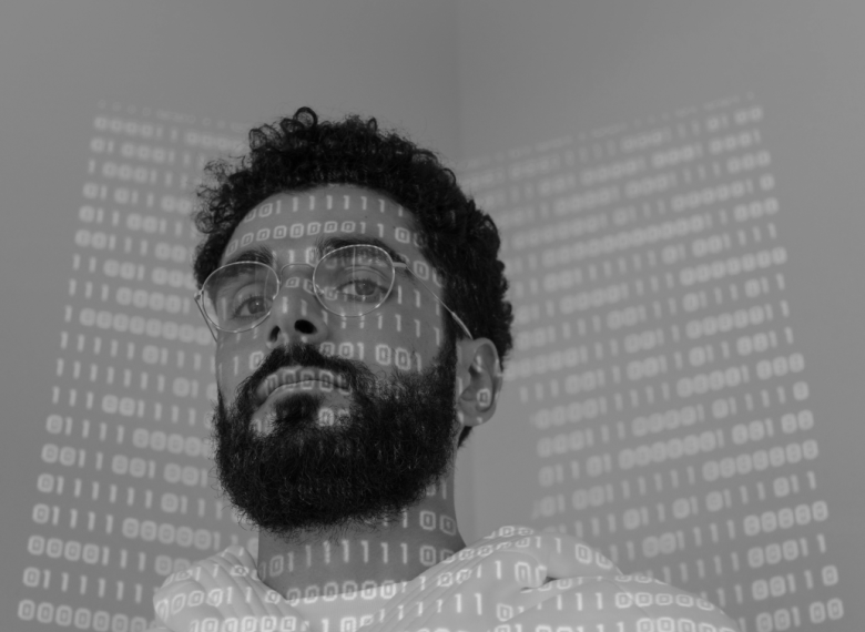 iamge of a developer with a code overlay showcasing the full-stack development that Ember provides
